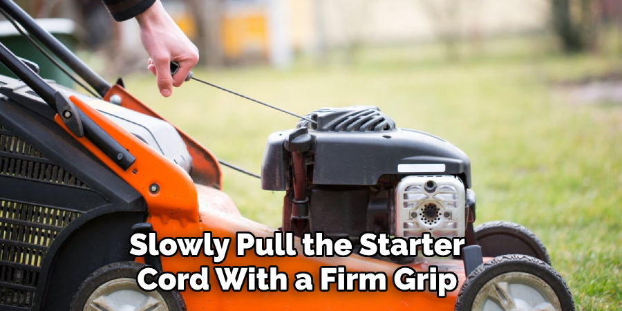 Slowly Pull the Starter Cord With a Firm Grip